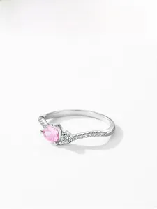 Macro detail of S925 silver ring featuring pink heart zircon and side pavé diamonds
