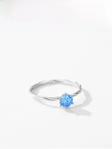 Close-up of S925 silver six-prong ring featuring a twisted band and blue zircon stone