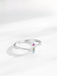 Detail of 925 sterling silver ring featuring four vertically set colorful cubic zirconia stones