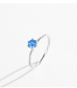 Macro detail of six-prong set blue zircon on a twisted S925 sterling silver ring band