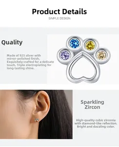 Macro detail of S925 sterling silver paw earrings with colorful cubic zirconia stones
