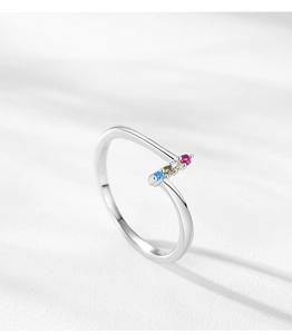 Detail of 925 silver open ring featuring four colorful zircons in a minimalist setting