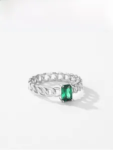Close-up of S925 silver chain ring with a rectangular emerald-cut green gemstone