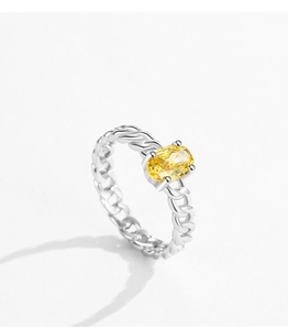 Macro shot of S925 silver ring featuring an oval yellow gemstone and woven band