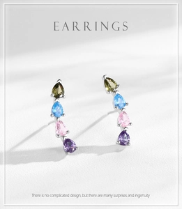 Macro detail of tear-drop rainbow cubic zirconia stones on S925 silver stud earrings