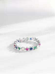 Detail of S925 silver ring with colorful zircons in a classic eternity band design