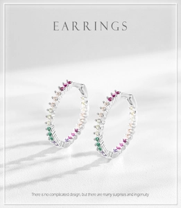 Macro detail of S925 sterling silver hoop earrings with colorful rainbow cubic zirconia