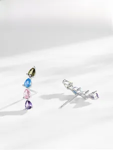 Detailed side view of silver drop rainbow zircon stud earrings with pear-cut gemstones