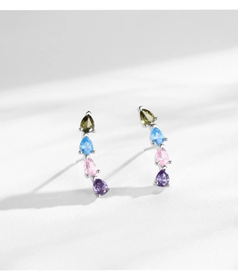 Macro detail of S925 silver stud earrings with four-color teardrop rainbow cubic zirconia