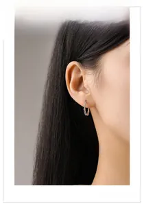 Close-up of rainbow cubic zirconia hoop earrings worn to show style and size