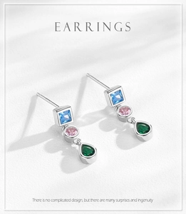 Close-up of S925 silver earrings with blue, pink, and green geometric zircons