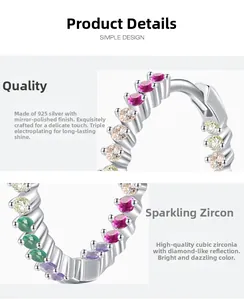 Detail of S925 silver hoop earrings with colorful cubic zirconia and polished finish