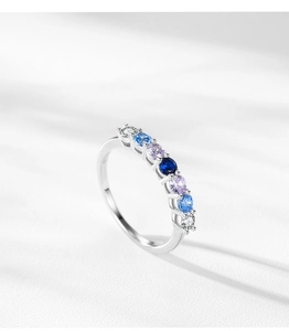Macro detail of S925 sterling silver ring with seven colorful blue gradient cubic zirconia