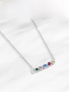 Macro detail of S925 silver necklace featuring five vibrant rainbow zircon stones