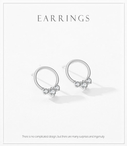 Detailed view of S925 sterling silver hoop earrings featuring three sparkling zircons