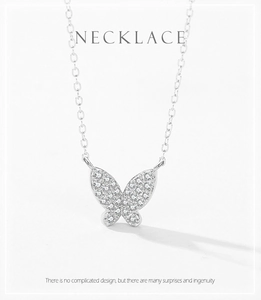Macro detail of silver butterfly pendant with pavé set cubic zirconia on fine chain