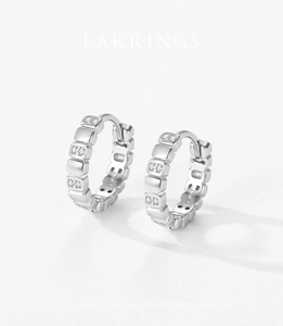 Macro shot of S925 sterling silver hoop earrings featuring micro-pave geometric pattern