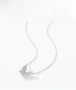 Detailed view of silver butterfly pendant with sparkling zircons on a delicate cable chain