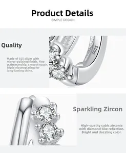 Dettaglio di orecchini in argento S925 con zirconi micro-incastonati e design semplice