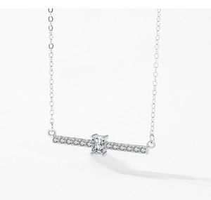 Macro shot of S925 silver necklace featuring emerald-cut stone and micro-pave crystals