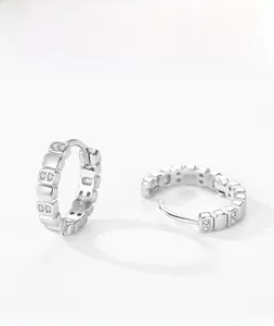 Close-up of geometric S925 sterling silver earrings with micro-inlaid zircon and S925 hallmark