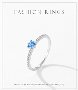 Detailed macro of S925 silver ring featuring a round sky blue zircon in a six-prong setting