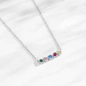 S925 sterling silver necklace with multi-colored geometric zircon pendants on white surface