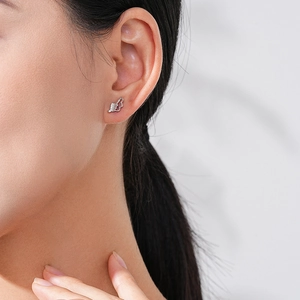 S925 sterling silver angel wing stud earrings with sparkling cubic zirconia on model
