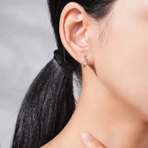 Elegant S925 sterling silver infinity earrings with sparkling zircon on a female model
