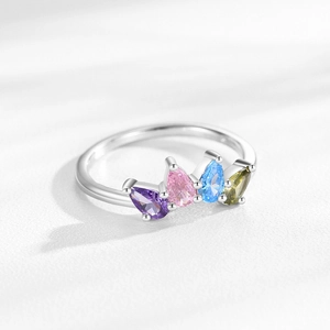 S925 silver crown ring with colorful pear-cut zircons on a white textured surface