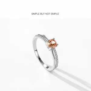Close-up of S925 silver ring featuring amber zircon center stone and pavé set white gems