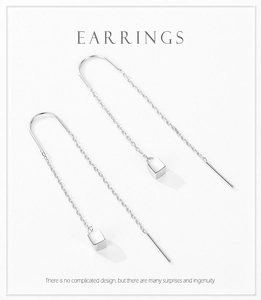 Macro detail of S925 sterling silver threader earrings with a geometric square pendant
