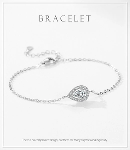 Detailed view of teardrop pendant bracelet with halo stones and adjustable cross chain