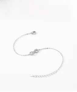 Macro shot of silver infinity bracelet with zircon pavé and lobster clasp detail