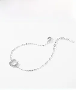 Macro detail of S925 sterling silver U-shaped bracelet with pave zircon and clasp