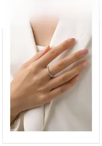 Detail of S925 silver criss-cross ring with micro-pave cubic zirconia on model finger