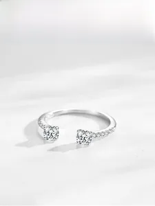 Close-up of S925 sterling silver bypass ring with two round-cut stones and pavé accents