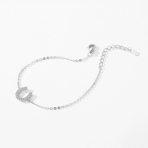 S925 sterling silver horseshoe bracelet with pavé cubic zirconia on a white background