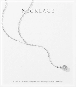 Macro view of S925 silver necklace with micro-pave round pendant and shimmering zircons