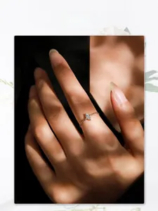 Detailed view of an elegant 925 silver chain ring with a marquise cut stone on a finger