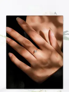 Detail view of S925 silver six-prong cubic zirconia chain ring on model with soft lighting