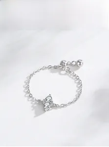 Macro view of adjustable silver chain ring with teardrop zircons and bead detail