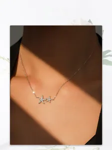 Elegant sterling silver starfish pendant necklace with pavé cubic zirconia on model