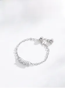 Macro shot of S925 sterling silver chain ring with three clear zircons and adjustable beads