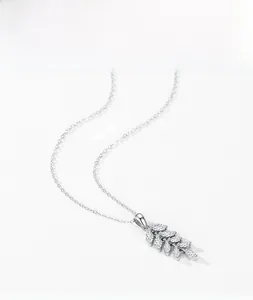 Macro detail of S925 sterling silver leaf pendant set with marquise-cut white zircons