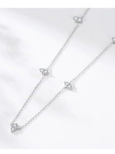 Macro shot of S925 sterling silver chain featuring heart-shaped bow pendants with zircons