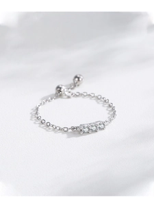 Macro shot of S925 sterling silver chain ring with three clear cubic zirconia stones