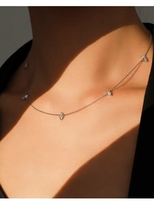 Close-up of S925 silver necklace with marquise-cut stones on a female neck