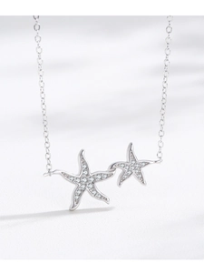 Macro shot of silver starfish pendant necklace featuring sparkling micro-pave zircons