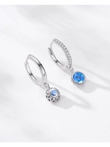Close-up of S925 sterling silver hoop earrings with blue zircon and pavé white stones